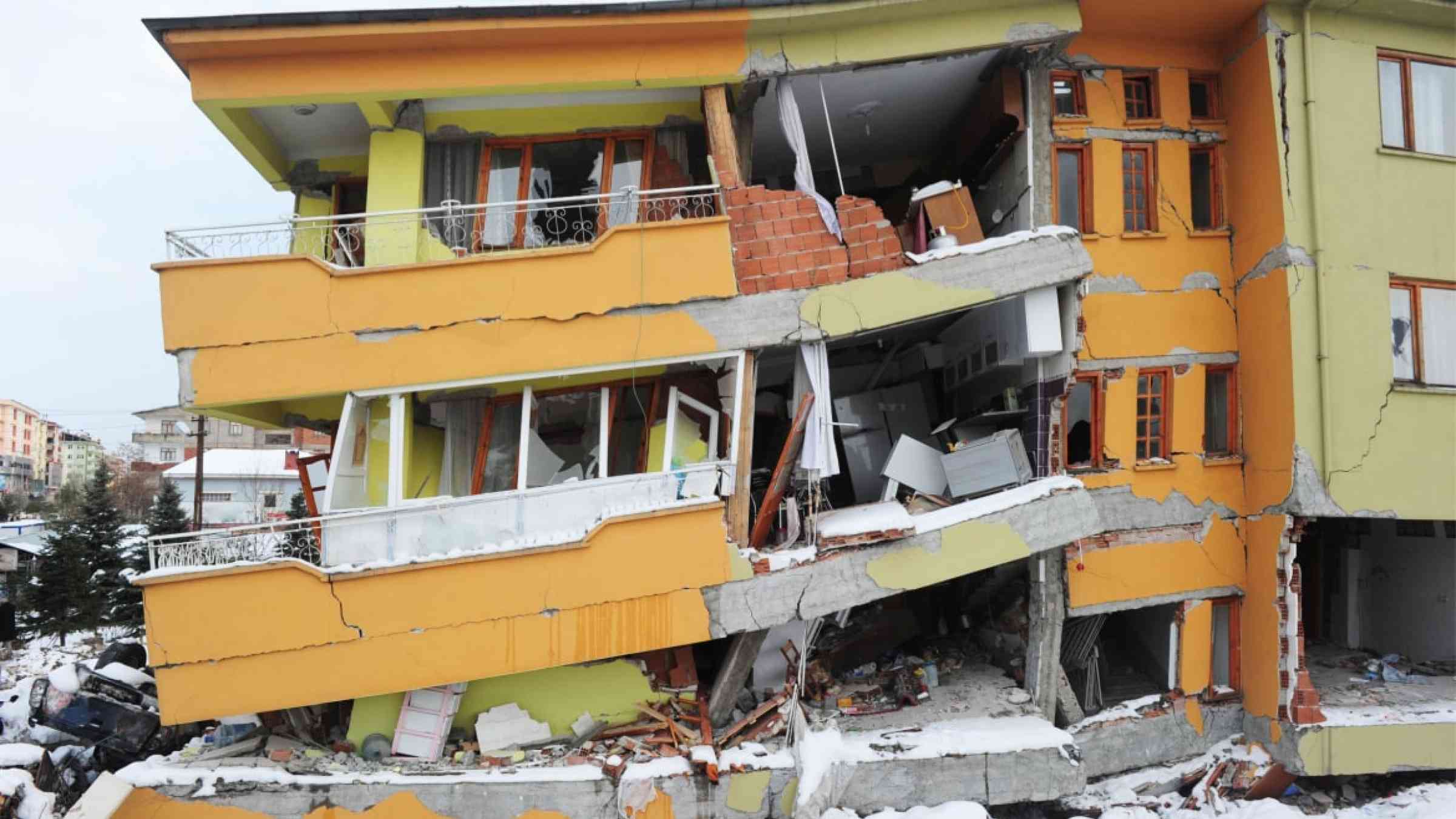 Yellow building collapsed after an earthquake.