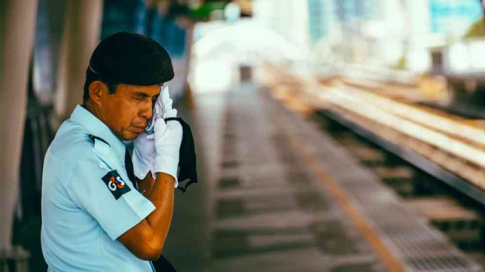 A security officer takes a break in the middle of a hot afternoon in Bangkok, Thailand