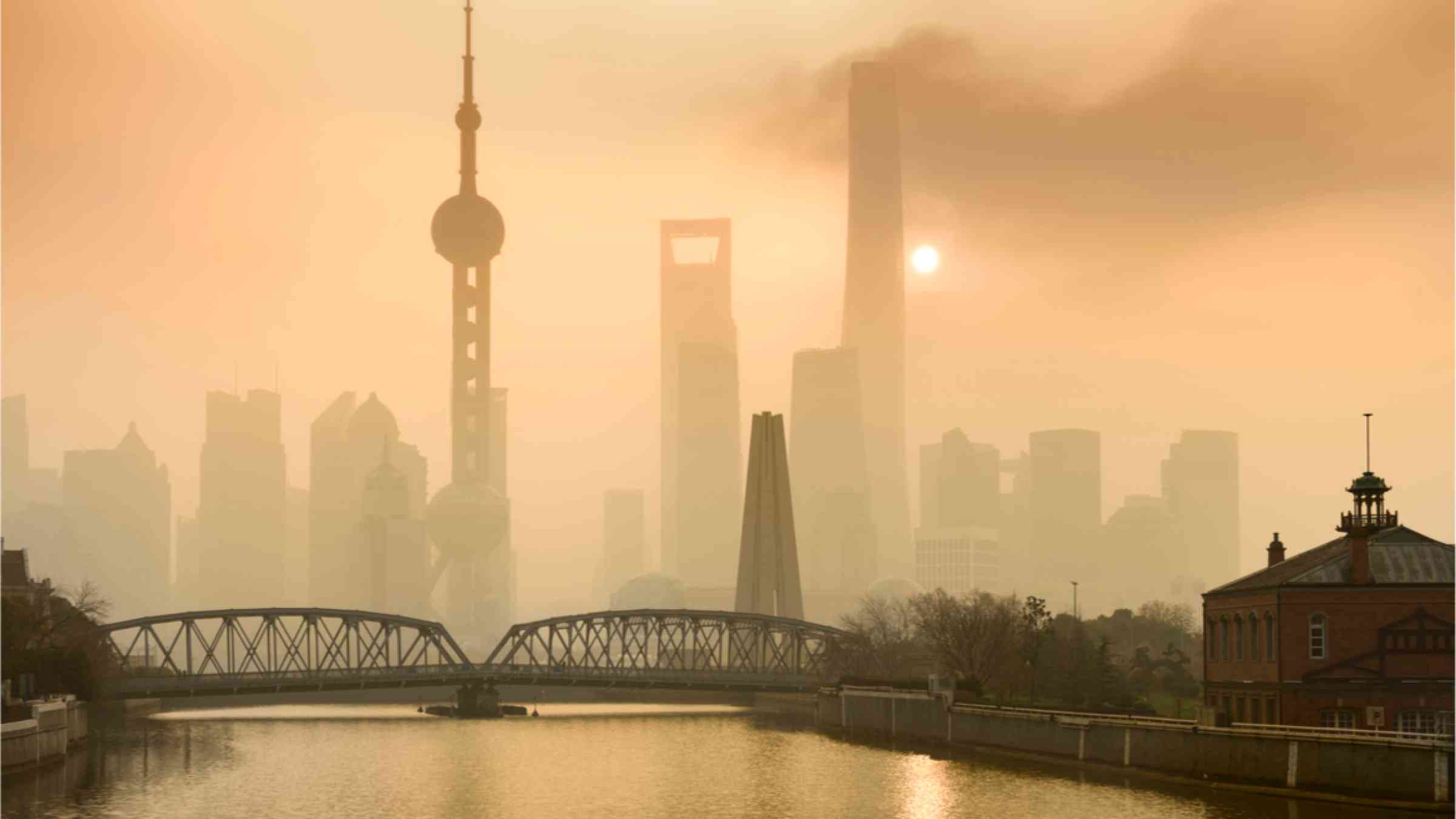 Shanghai Financial Center and modern skyscraper city behind pollution steam, view from background in Shanghai, China. 