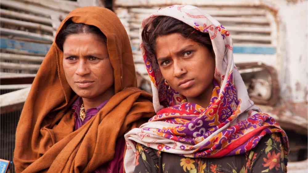 Two women in a slum in Asia.