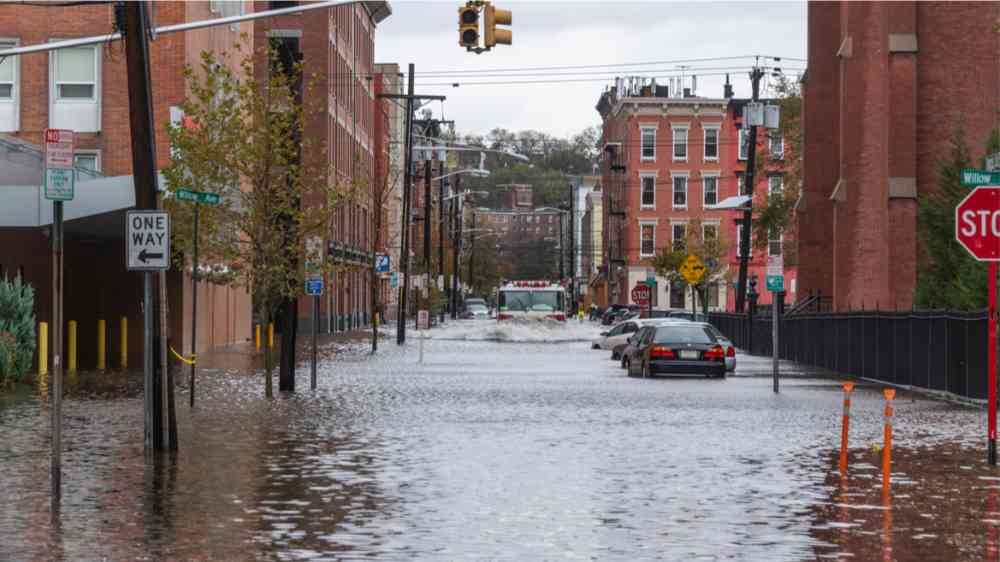 Superstorm Sandy Hoboken, NJ. Flooded streets and cars at the corner of Willow ST and 4th ST. Fire truck plowing through.