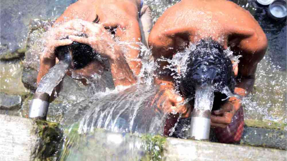 People take bath to keep them self cool from heat wave