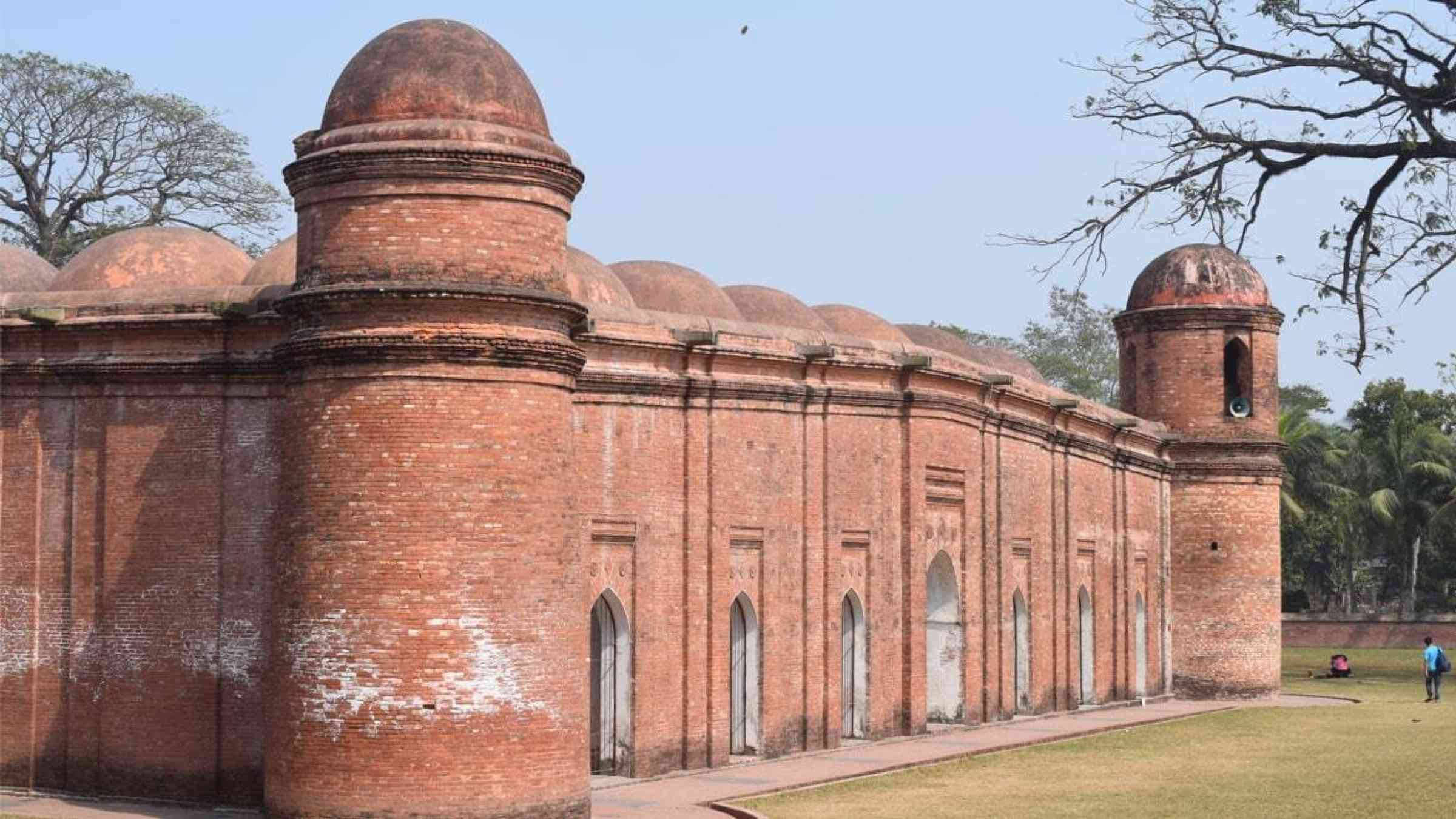 The walls of Bagerhat's sixty dome mosque are smudged white by the saline air