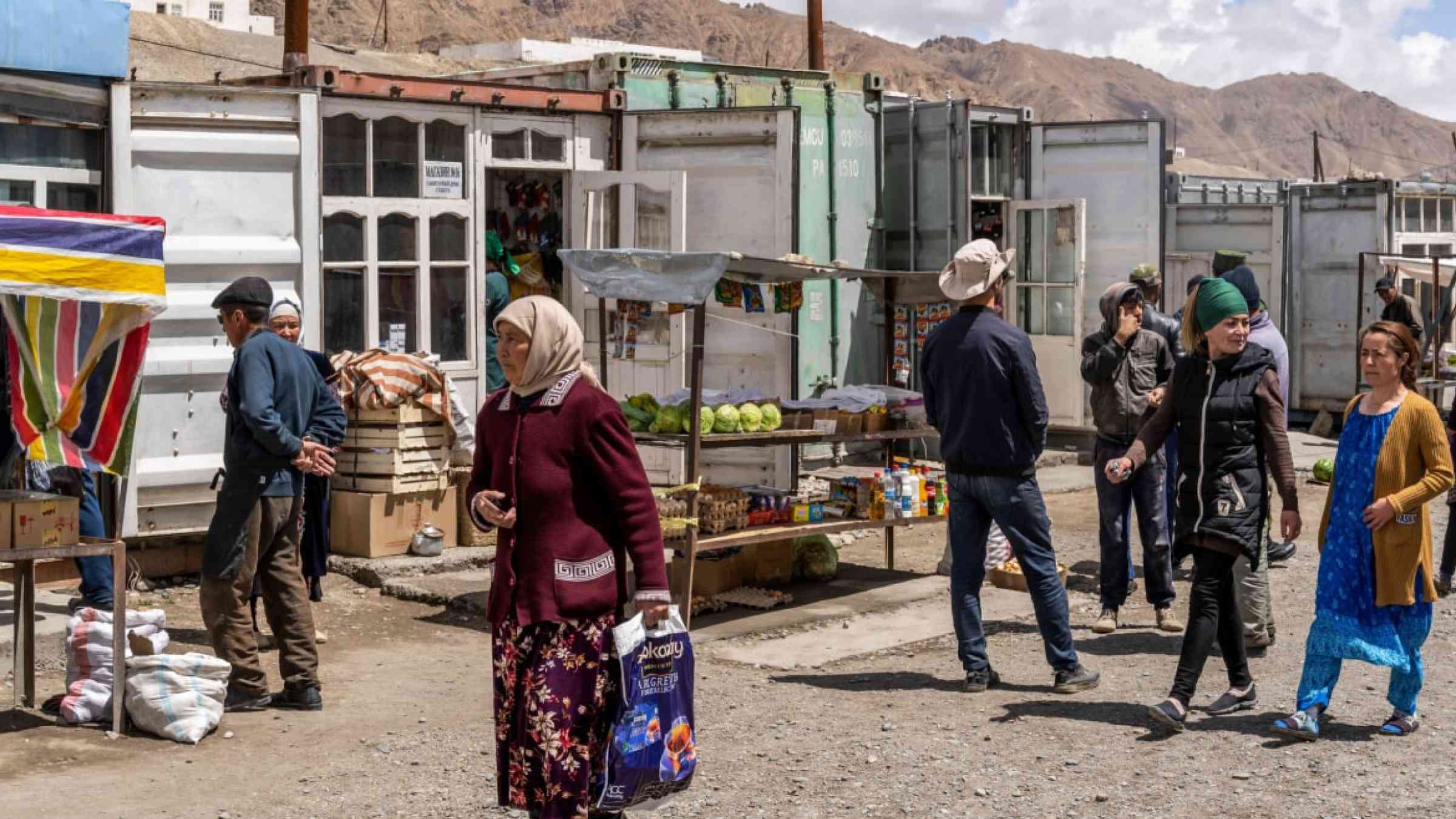 People walking through their village in Tajikistan.