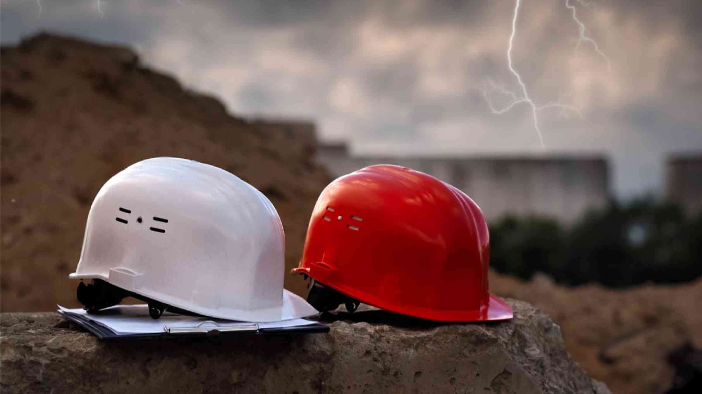 Builder helmets with lightning in the background
