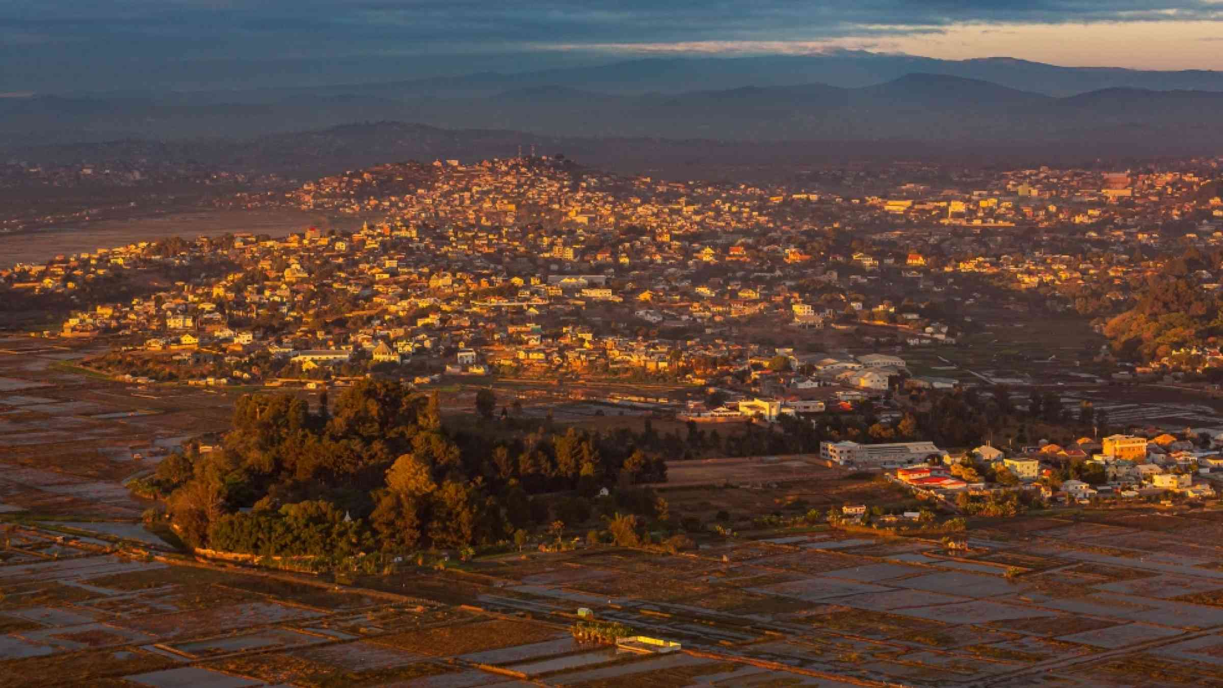 Photo of a city in Madagascar from the sky with mountains in the background