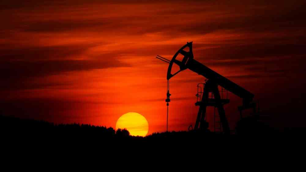 Pump-jack mining crude oil with the sunset