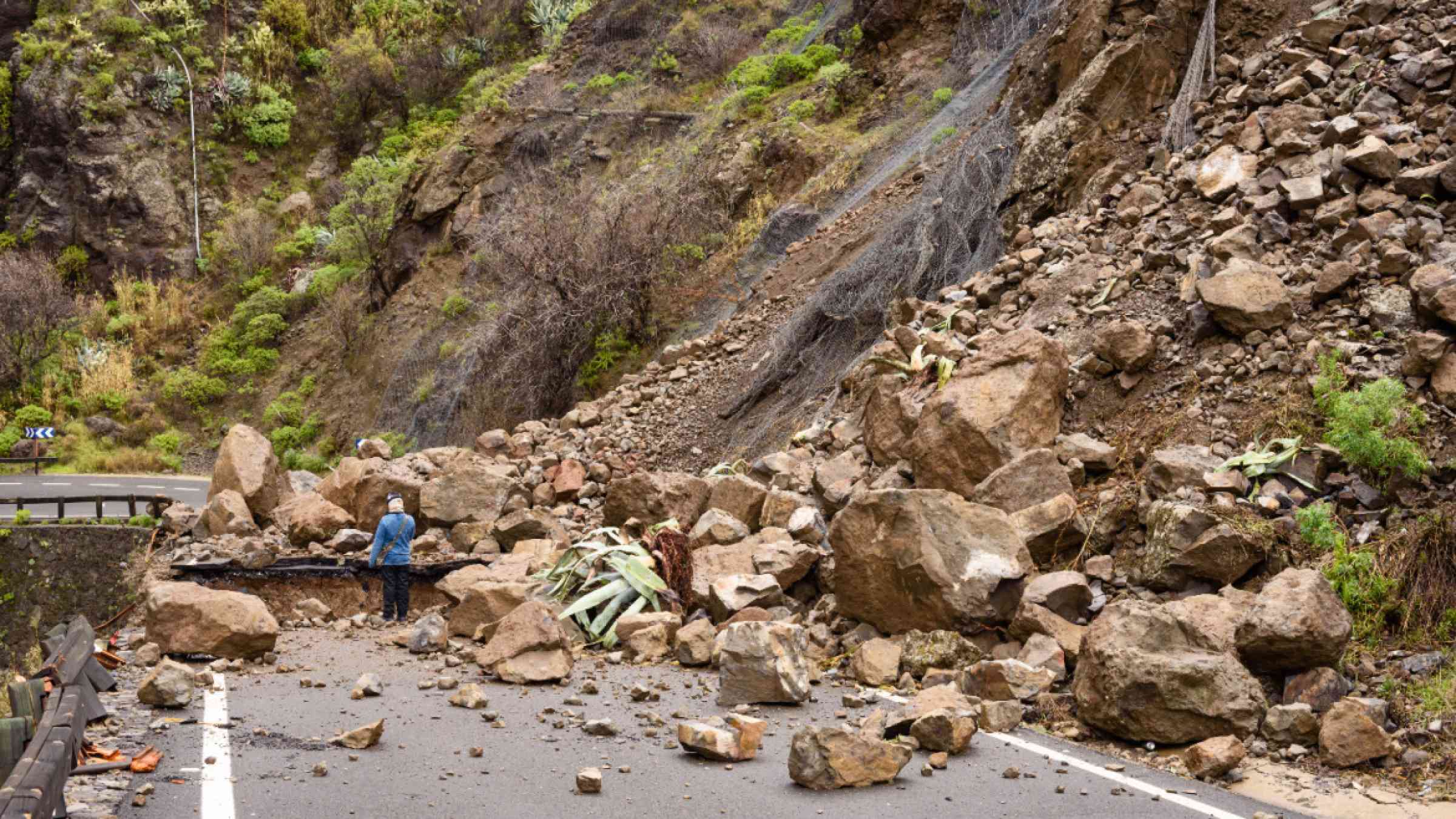 Rocks block a road in Tejeros, Gran Canaria, Spain after heavy rains trigger landslides and rockfalls