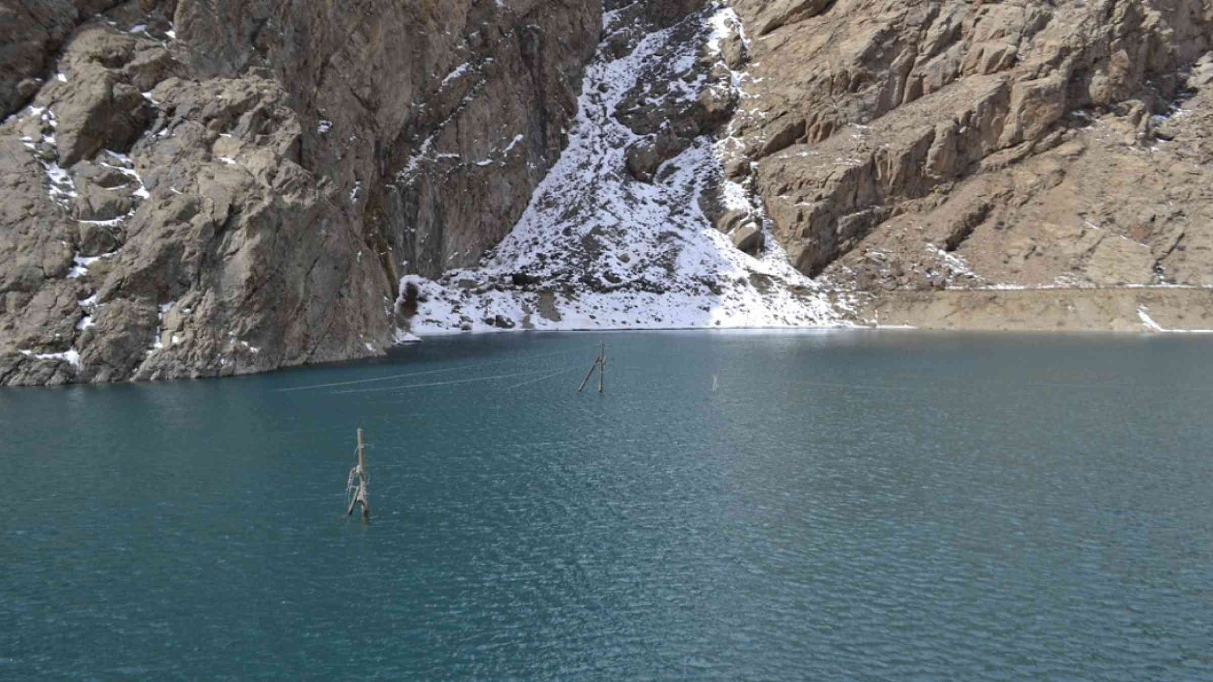 The remains of a glacier in Tajikistan leading down to a lake.