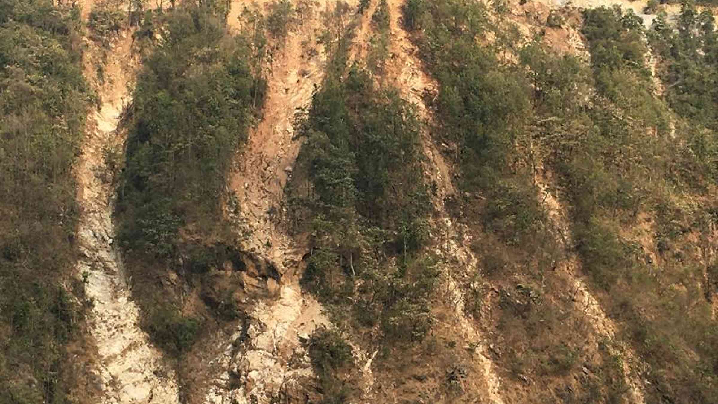 Landslide scars run down from a poorly built road near Mirmee in central Nepal like frozen waterfalls. Jane Qiu