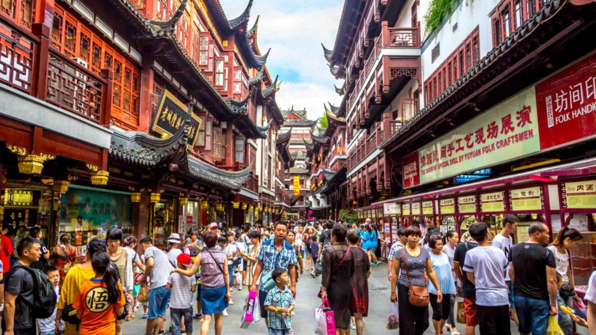 People in a street in Shanghai. LMspencer/Shutterstock