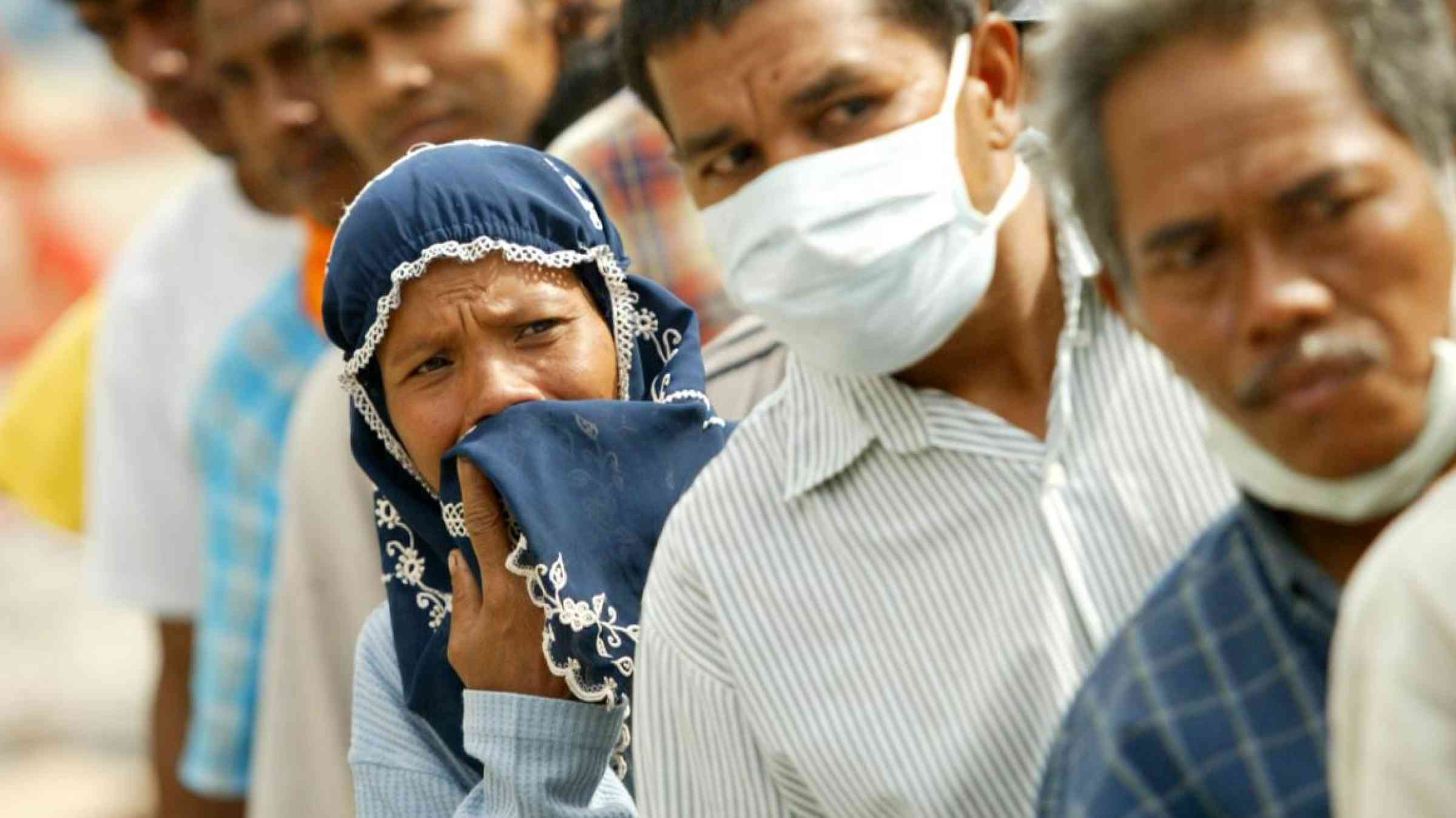 People standing in line following the 2004 tsunami in Indonesia.