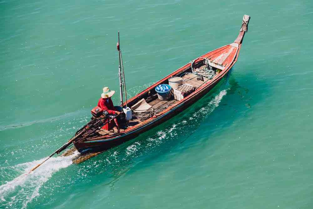 Local fisherman heading long tail boat to the pier at Koh Libong island, Trang province.