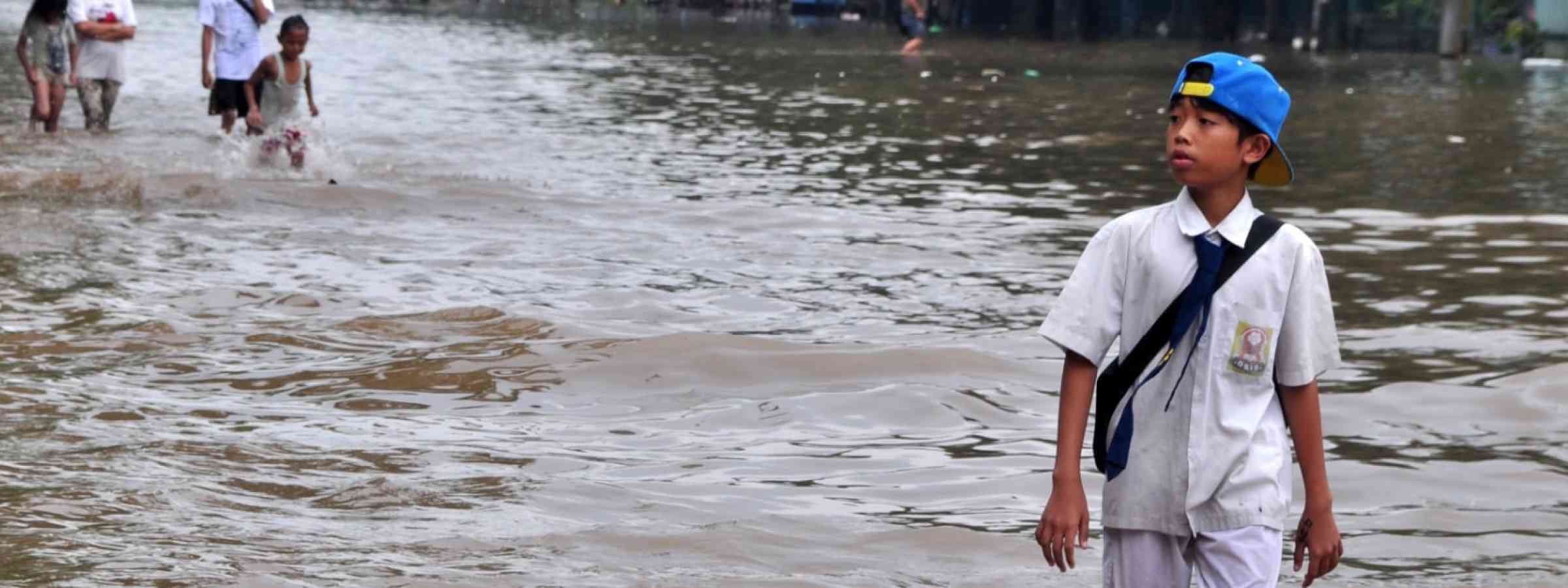 A child walking across flooded school in Jakarta - Indonesia