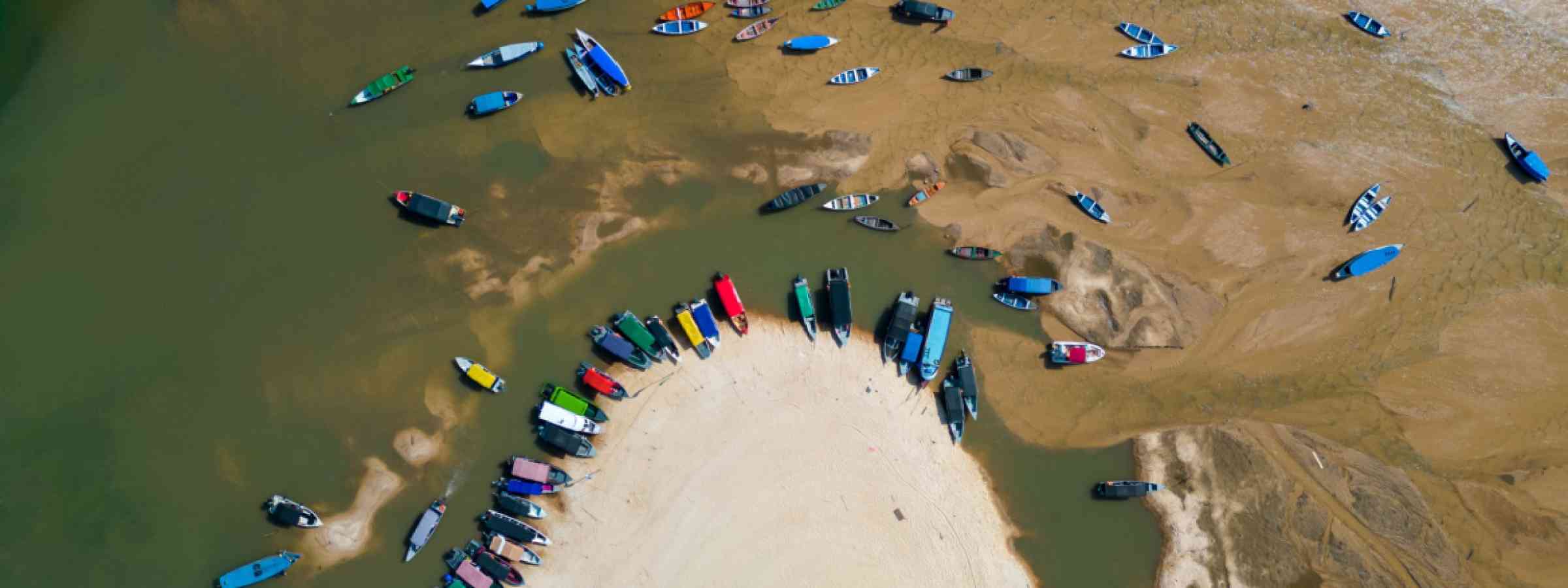 Small boats stranded in the nearly dry bed of the Tapajos river in Alter do Chao, Santarem, Brazil, during the amazonian drought in the second half of 2023