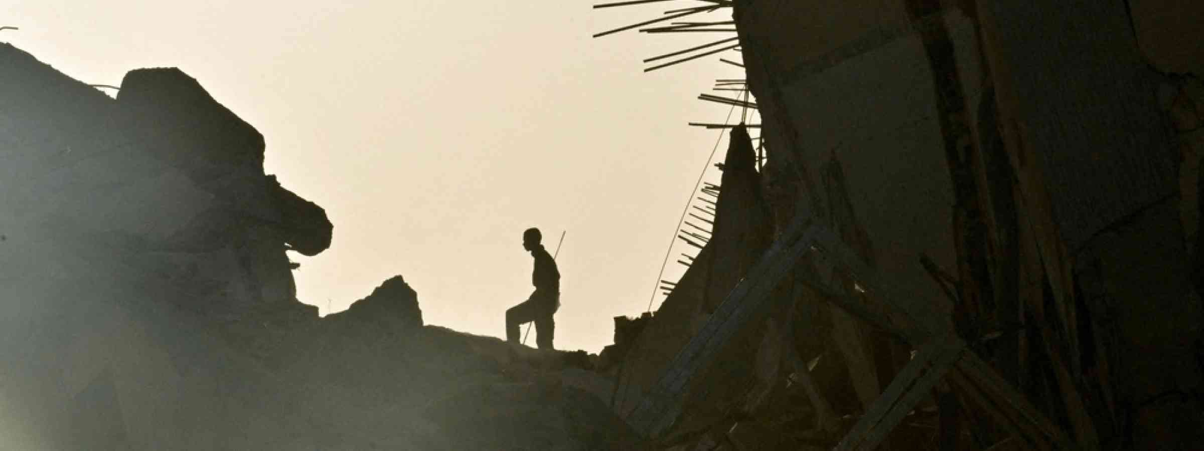 Venezuela earthquake A person searches for his family amid the remains of a damaged building in the aftermath of powerful earthquakes in La Guaira as recovery efforts continue.